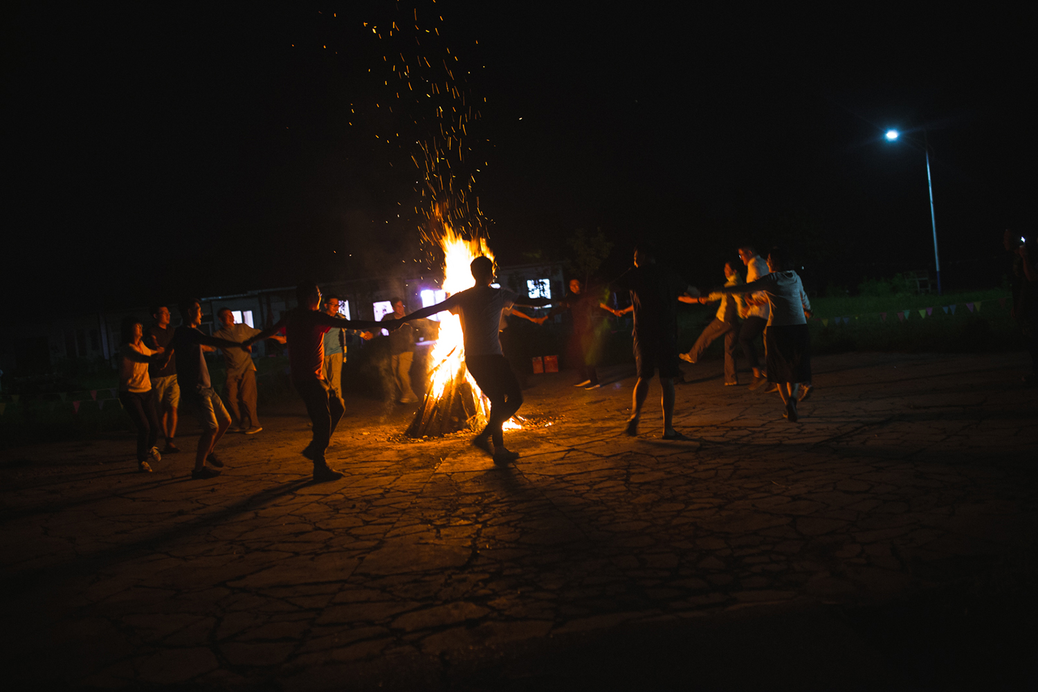 Heilongjiang Province, August 2017 Visiting university professors from Harbin take part in a fire ritual put on as a show by local Oroqen entrepreneurs. Interest in an ethnographically focused tourism industry and folk rituals are growing across contemporary China. 