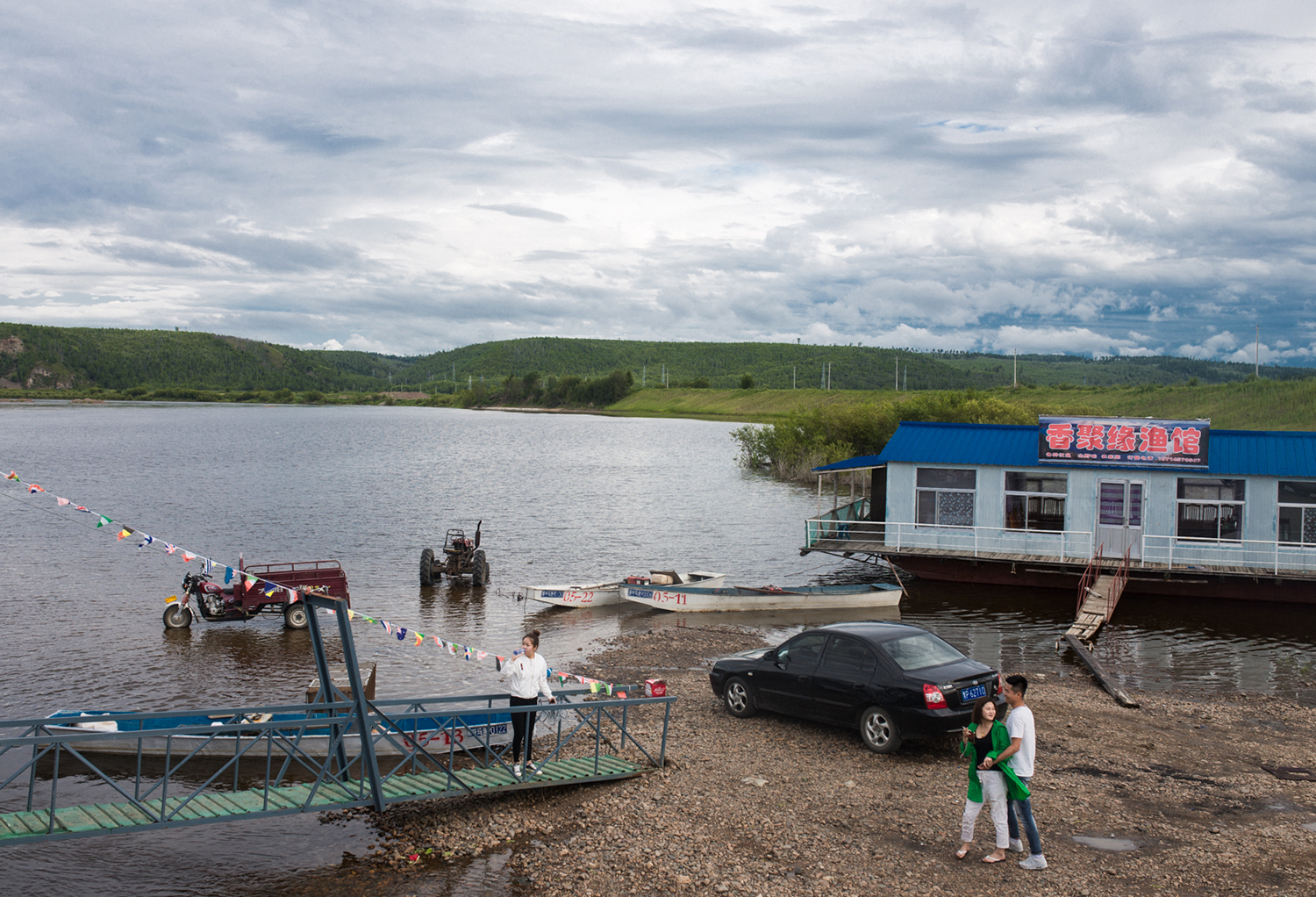Heilongjiang River, August 2017 Young Oroqen depart after lunch on a restaurant on the river. The Heilongjiang (or Amur in Russian) acts as the border between China and Siberia and historically Oroqen and many other ethnic groups moved between the two regions. 
