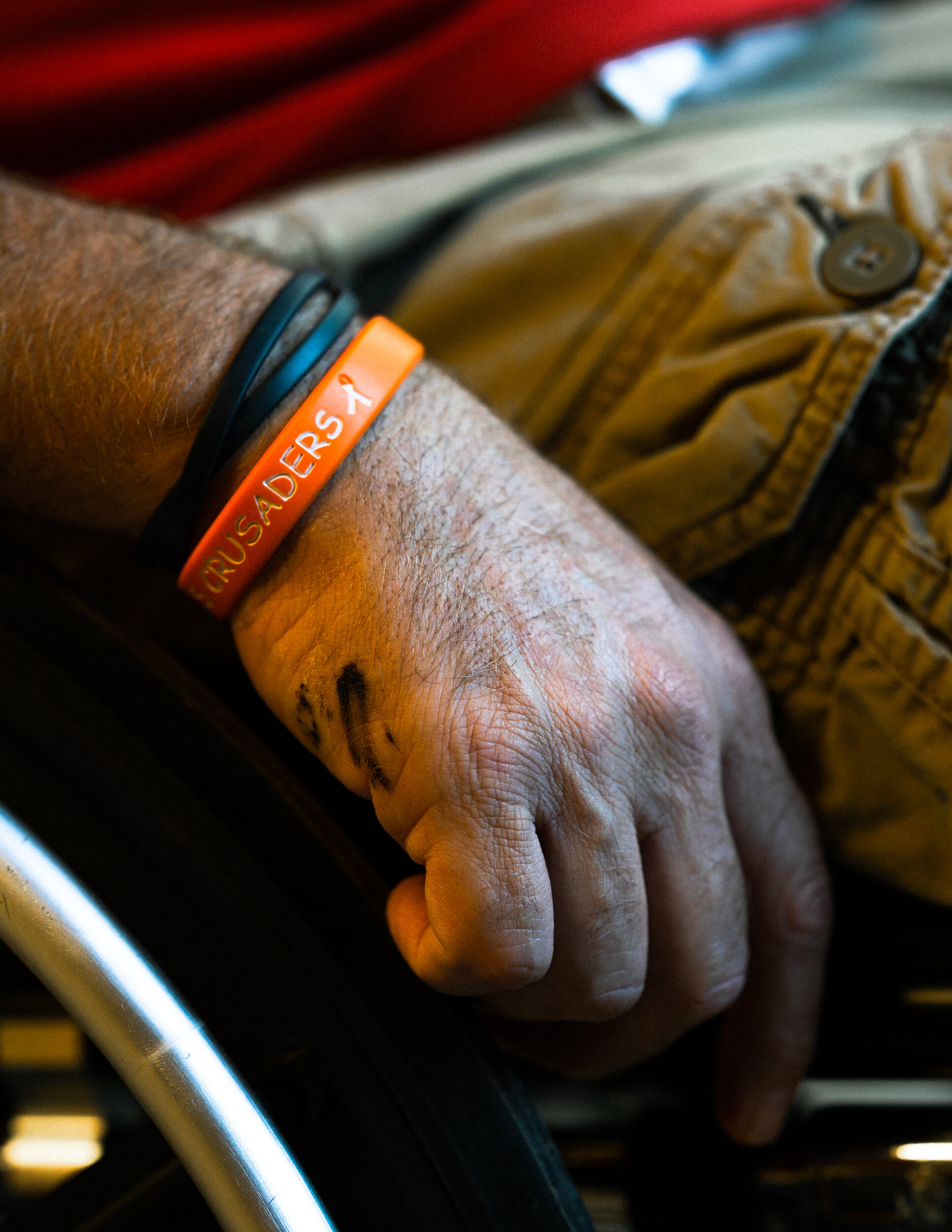 Grease from Clark’s wheelchair stains his hand as he sits in his garage. Before the accident, Clark worked twelve or more hours a day operating the family company’s vehicles. As an active boss, he much prefers being out driving trucks to working behind a desk.