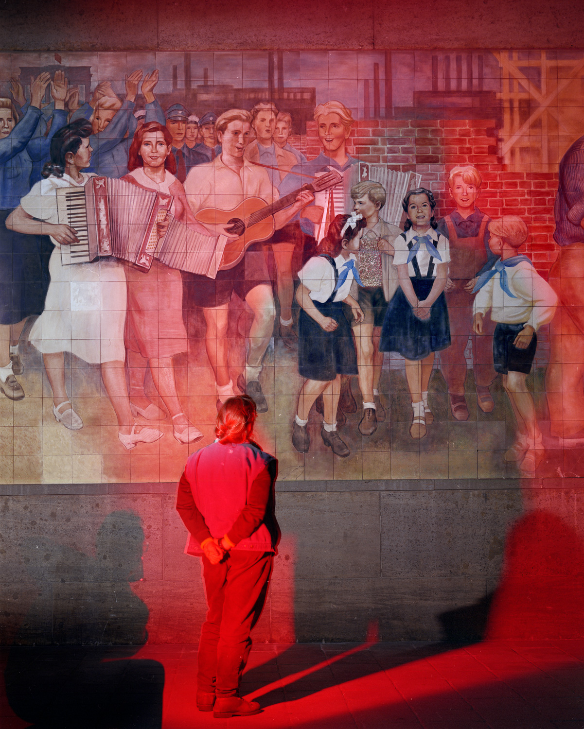    
  
 
  
    This is my wife Judy Settle standing before a mural by Max Lingner (1952?) which is on an exterior wall of Detlev-Rohwedder-Haus in East Berlin. This building was the location of the Air Ministry in the Nazi period, and later the Treu