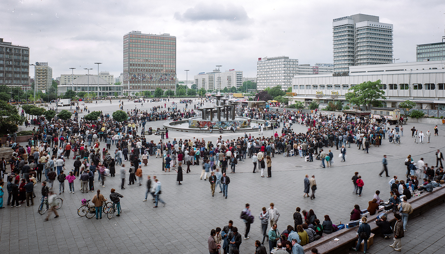 This crowd is in Alexanderplatz in East Berlin one or two days before East German money was no longer useful as currency. The people in the plaza are changing money by exchanging cheap east bloc consumer goods for western cash . It was not unusual to see someone with a roll of East German Marks that was nine or ten centimeters in diameter. The largest denomination in DDR currency was 100 marks and the value of those marks was in free fall the last few days. All ddr citizens could convert 4000 marks at par, investments and other monies above that were traded at 2:1 and last minute speculative monies only traded at 3:1. Crazy days.
Normal
0
false
false
false
EN-CA
X-NONE
X-NONE
/* Style Definitions */
table.MsoNormalTable
{mso-style-name:"Table Normal";
mso-tstyle-rowband-size:0;
mso-tstyle-colband-size:0;
mso-style-noshow:yes;
mso-style-priority:99;
mso-style-parent:"";
mso-padding-alt:0cm 5.4pt 0cm 5.4pt;
mso-para-margin-top:0cm;
mso-para-margin-right:0cm;
mso-para-margin-bottom:8.0pt;
mso-para-margin-left:0cm;
line-height:107%;
mso-pagination:widow-orphan;
font-size:11.0pt;
font-family:"Calibri",sans-serif;
mso-ascii-font-family:Calibri;
mso-ascii-theme-font:minor-latin;
mso-hansi-font-family:Calibri;
mso-hansi-theme-font:minor-latin;
mso-fareast-language:EN-US;}