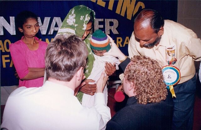 Evangelist Kevin in India, laying his hand on a leprous baby, for Jesus Christ to heal him. #JesusHeals