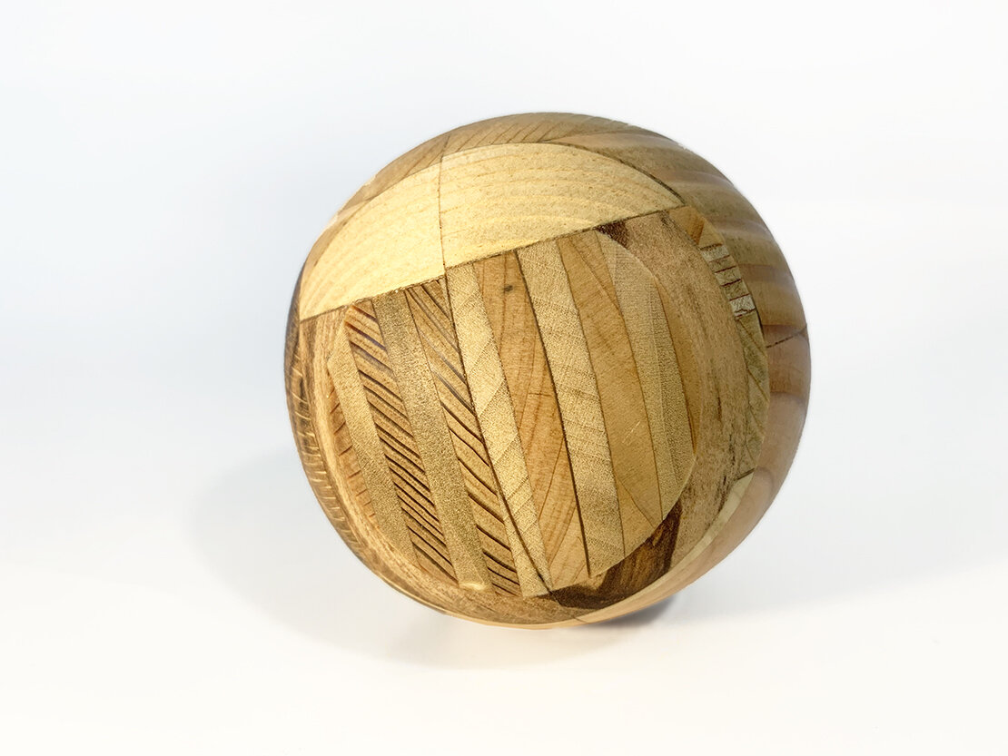 Sean Miller, Cosmic Event Ball, meteors and space dust sealed into a sphere made of wood pulled from architecture from multiple museums and art centers, 2020 