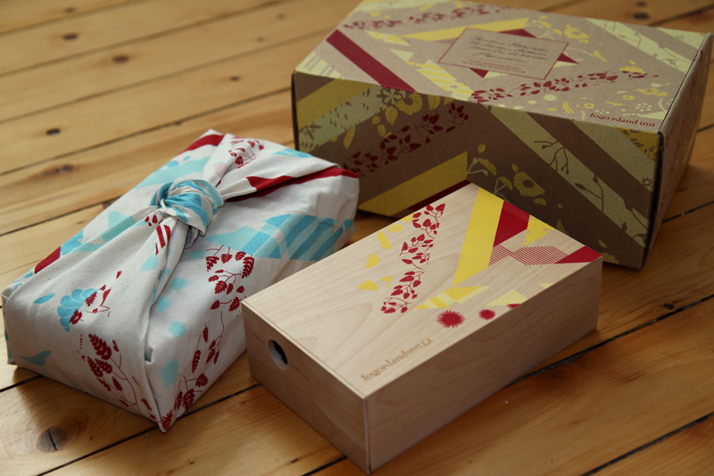 Packaging for word of mouth marketing campaign: wooden box with a peekaboo hole with a miniature diorama of a room at the Inn