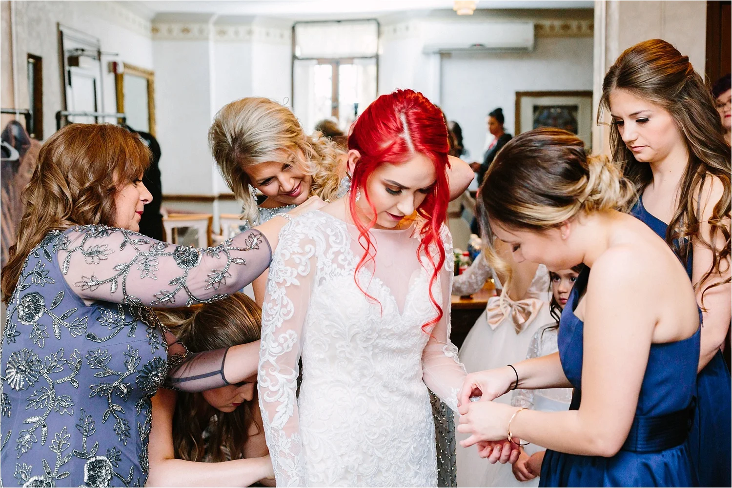 Some of my favorite photos from every wedding. Mamas and bridesmaids helping the bride with the dress.