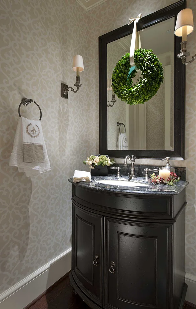 A subtle, tone-on-tone pattern in this Highland Park, Dallas powder room keeps the wallpaper from overwhelming the small space.