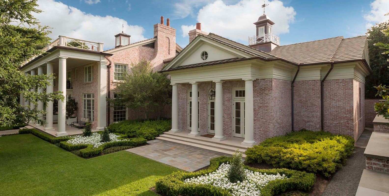 Like many famous Neoclassical buildings, this home by Ralph Duesing in Westover Hills has a large triangular pediment. (This photo is copyright of Ralph Duesing Architect, LLC . Chambers Interiors & Associates was granted permission to feature this image).