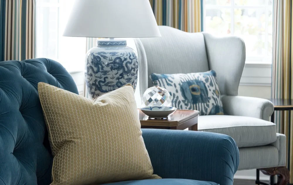 In the living room of this sorority house at SMU in Dallas, we paired a yellow pillow with a small-scale pattern and a blue pillow with a large-scale ikat pattern. Although the pillows are completely different, both of them fit into the overall color scheme of the room.