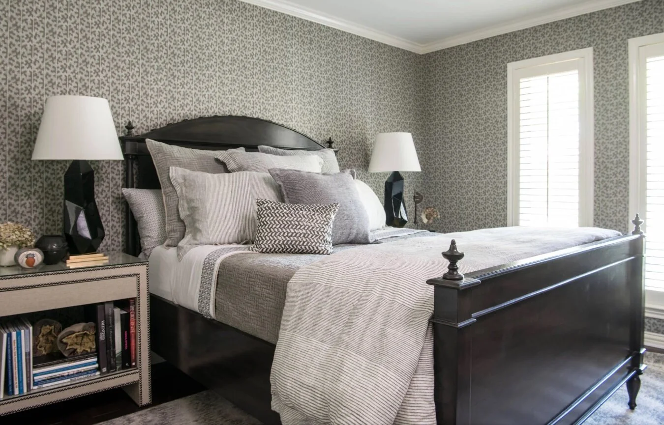Pictured here is another guest bedroom from the Dallas ranch home mentioned earlier. You can spot many different kinds of patterns here, but because they are all in various shades of gray, they do not clash with one another.
