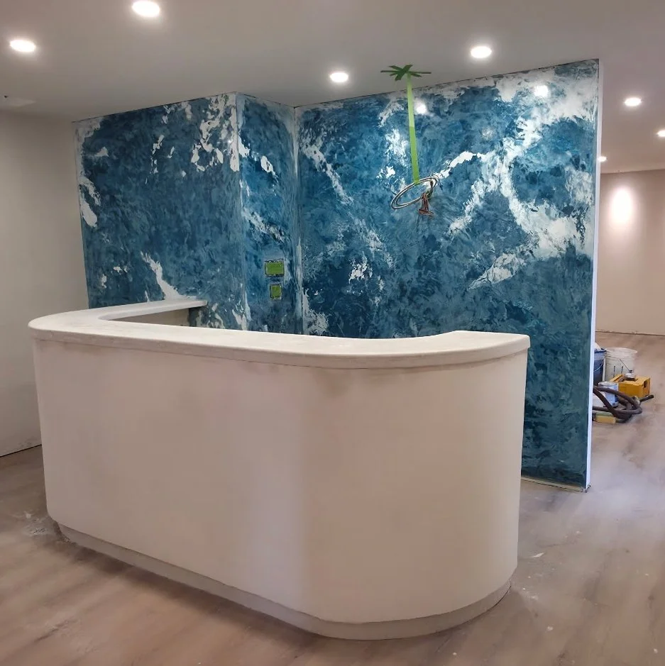  This blue feature wall at reception was inspired by a tranquil cloudy sky. Created using a very traditional technique that creates more depth and variation. By combining Marmorino, Gracello and Fresco finishes into one wall we have created a unique 
