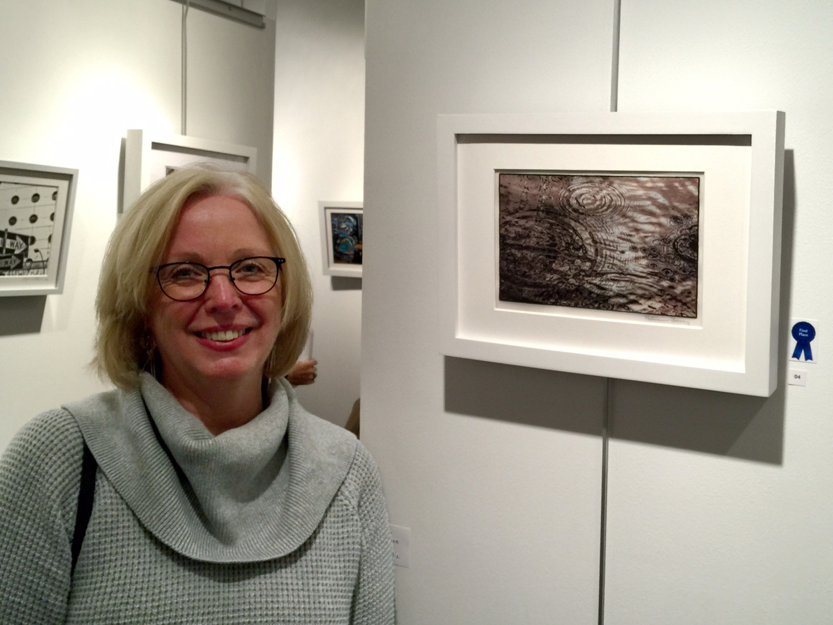 First Place Prize winner Patricia Beary with her work, Worlds Collide