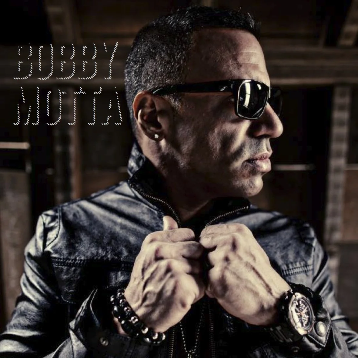Bobby Motta headshot with sunglasses and leather jacket