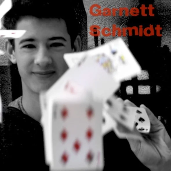 Garnett Schmidt promotional image springing cards towards the camera