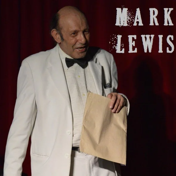 Mark Lewis doing a mind reading trick with an envelope at the Crimson Lounge