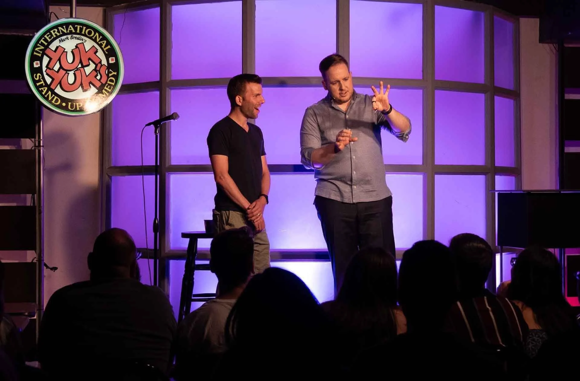 James Alan linking finger rings on stage at YukYuks in Toronto