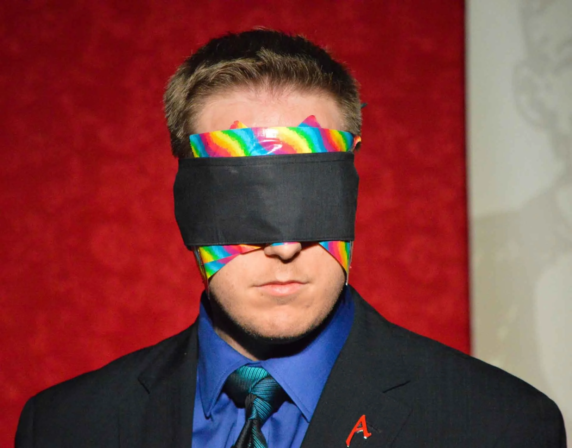 James Alan blindfolded with rainbow duct tape for pride during Magic Tonight in Toronto