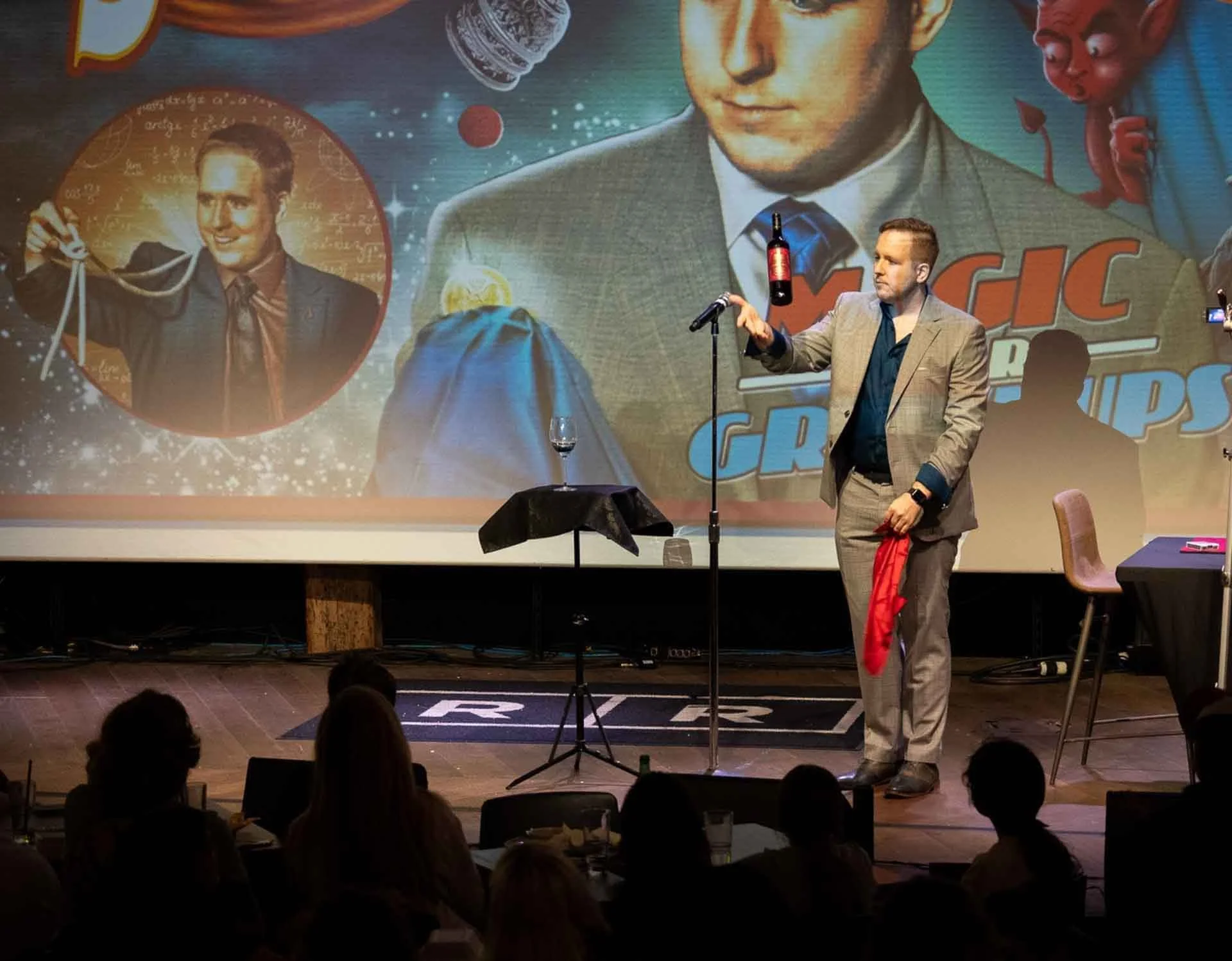James Alan with a floating wine bottle on stage at the Rec Room in Toronto