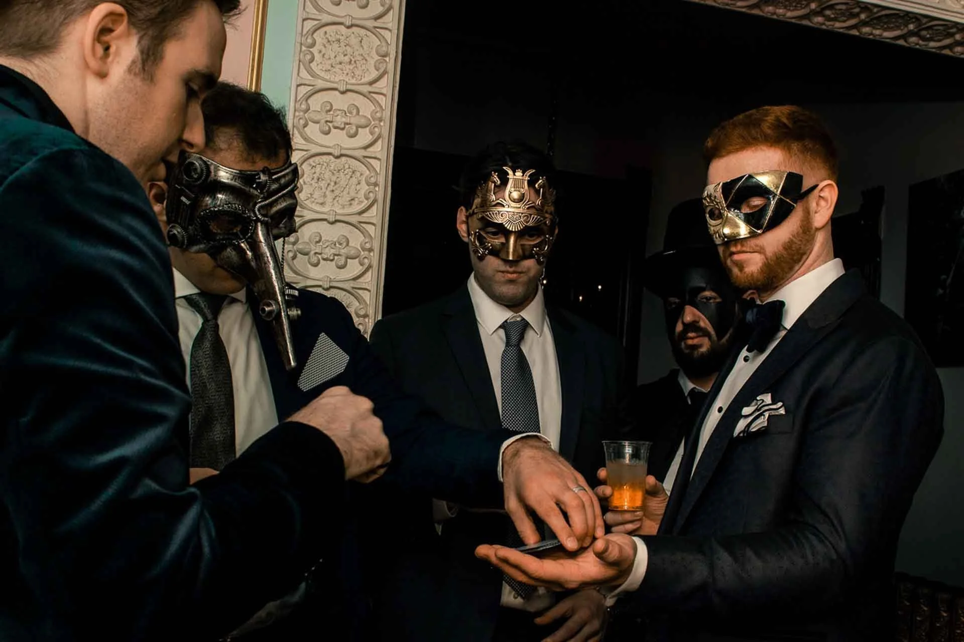 James Alan does a card trick at a masquerade ball in Toronto