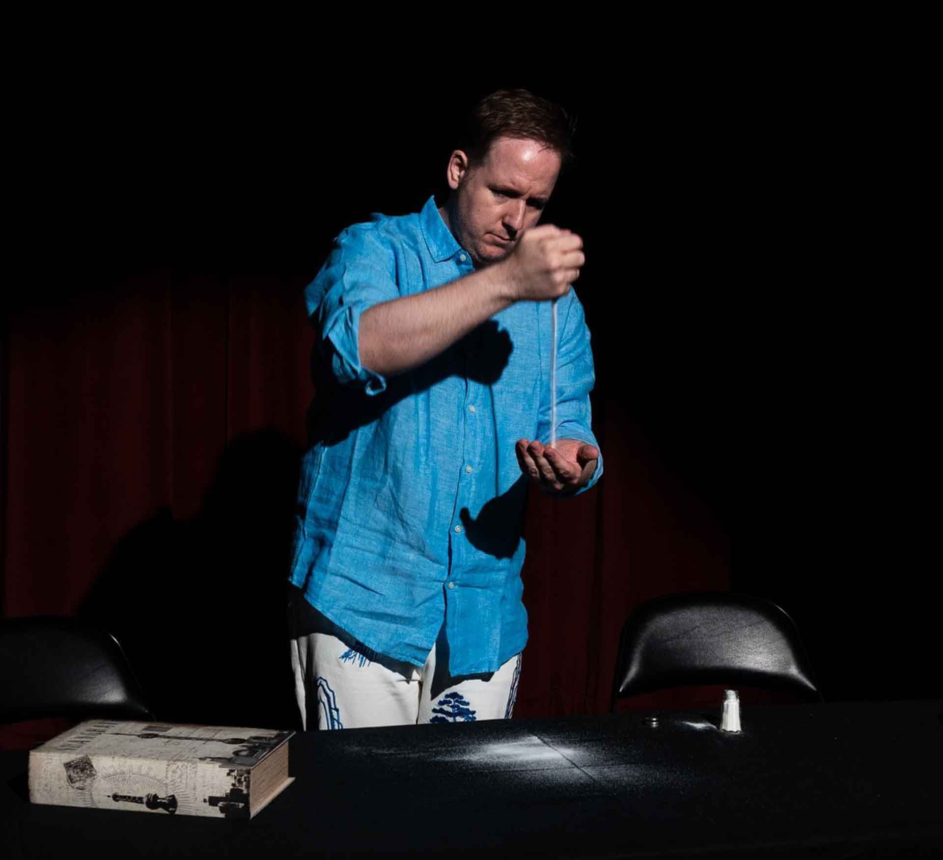 James Alan does a trick with salt at the Toronto Fringe Festival