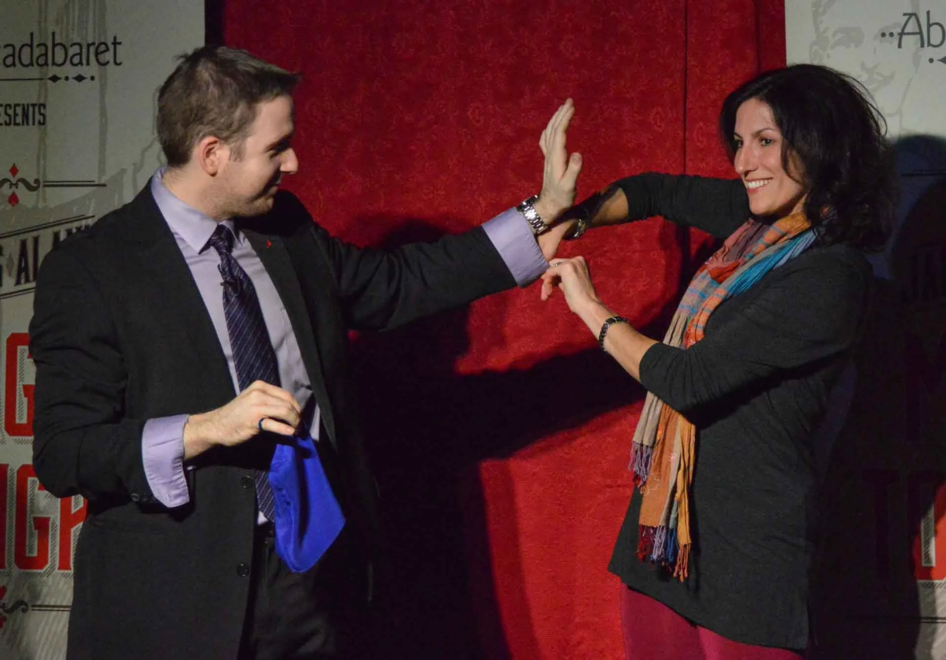 Audience member checks up James Alan's sleeve during a magic trick at the Crimson Lounge in Toronto