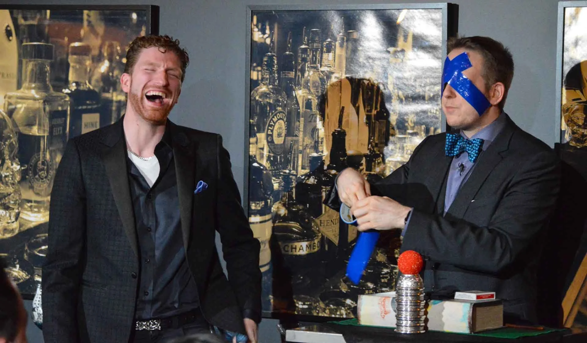 James Alan being blindfolded with duct tape for Magic and Martini at Spirit House