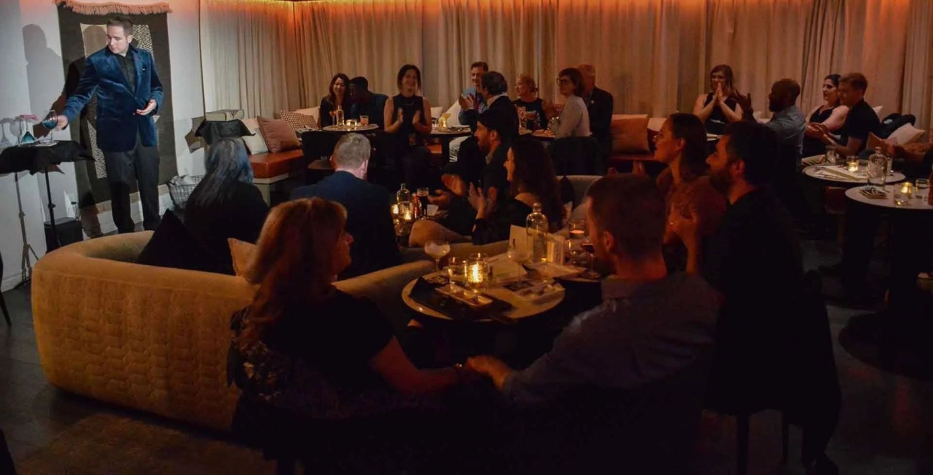 James Alan performing in front of an audience sipping cocktails for Magic and Martini at suite 114 in Toronto