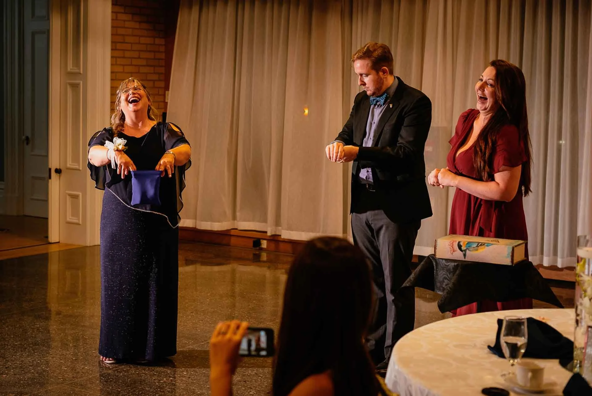 James Alan performing at a wedding assisted by two audience members in Brampton