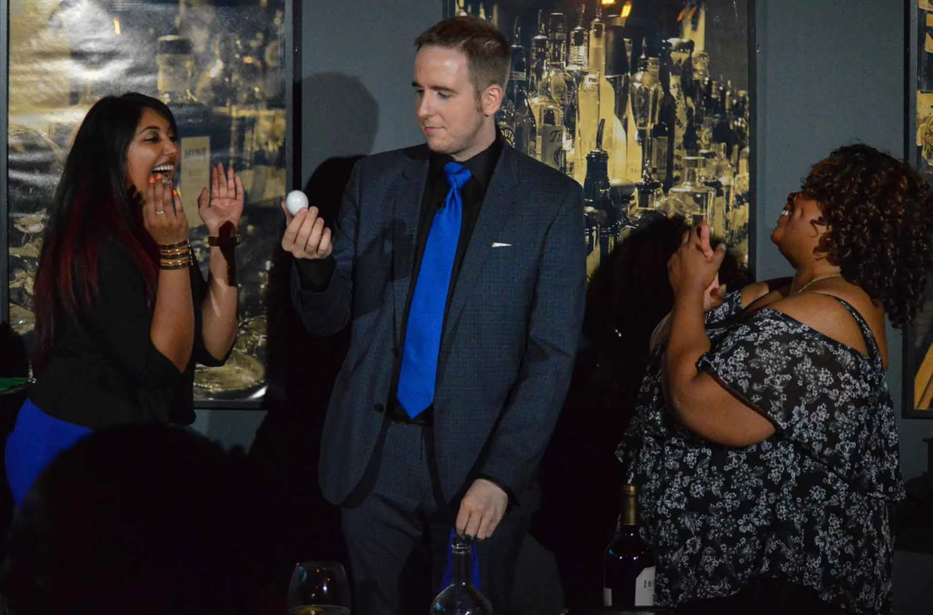 two audience members react to james alan doing magic with an egg at Magic and Martini in Toronto