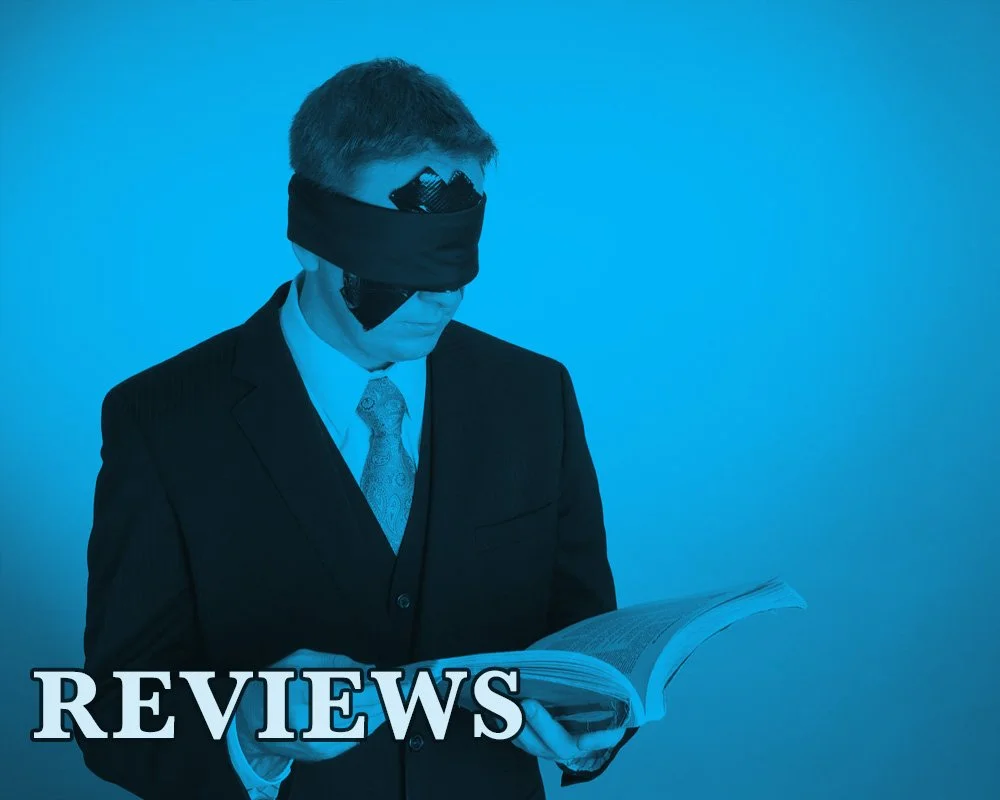 Link to Reviews Page James Alan blindfolded with duct tape reading an old book