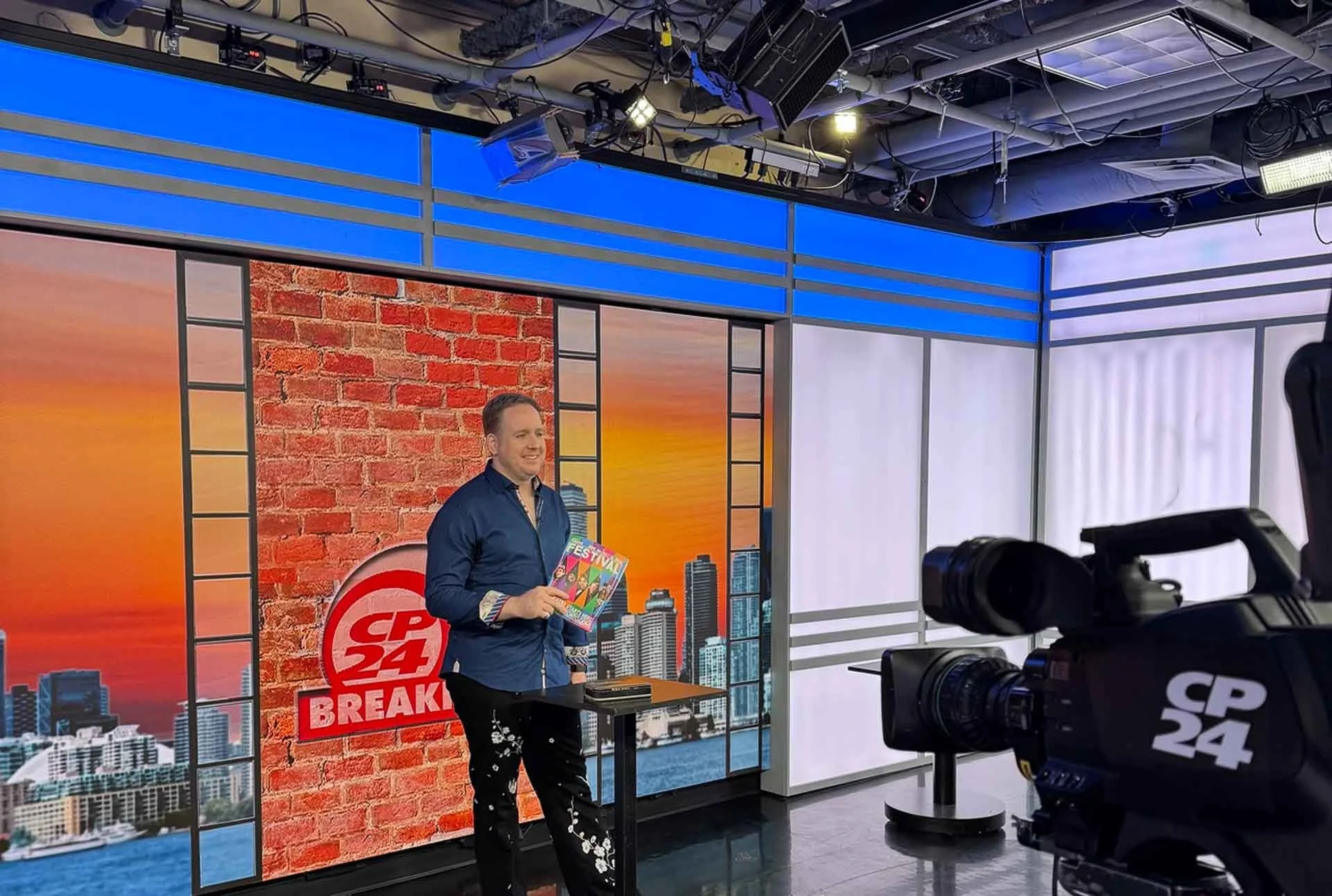 James Alan in studio at CP24 with Toronto Fringe Festival program
