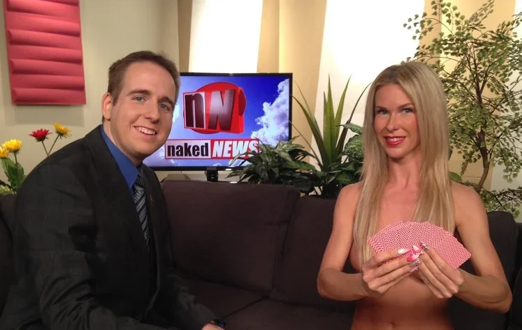 James Alan on the set of the Naked News in Toronto with topless anchor strategically covered with cards