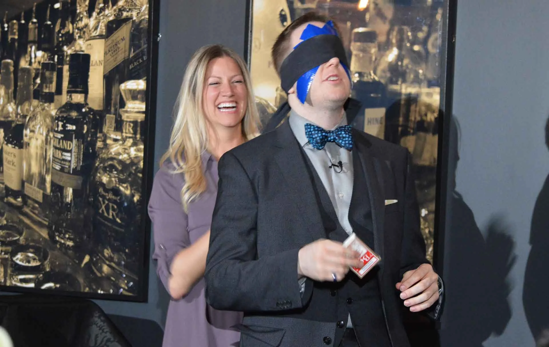 James Alan being blindfolded with laughing spectator on stage at Spirit House in Toronto