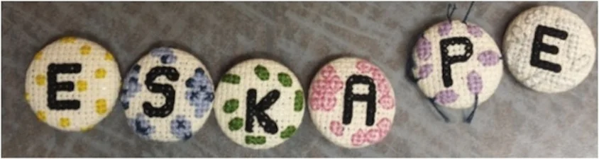 CROSS-STITCHED "ESKAPE" KEYCHAINS TO RAISE AWARENESS ABOUT ANTIBIOTIC-RESISTANT PATHOGENS. PHOTO CREDIT: ASHLEY CAMPBELL.
