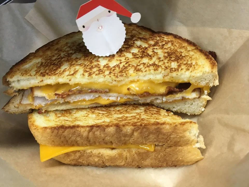 Smoked sliced turkey, crispy bacon, house made slob sauce, and melted sharp cheddar cheese on grilled sourdough bread topped with Santa! The Turkey Trot was one of the grilled cheese sandwiches delivered during the 12 Days of RSK’s.