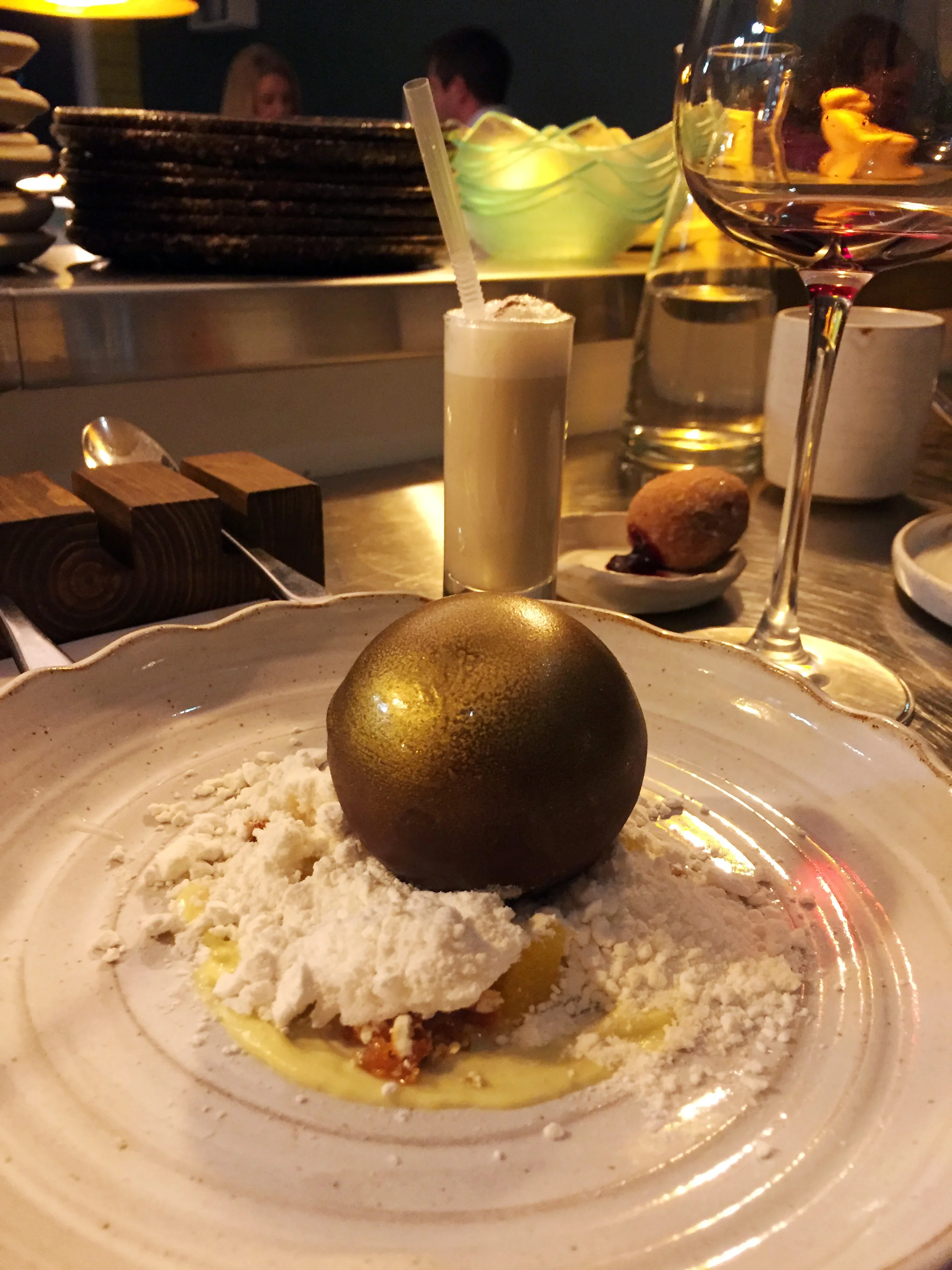 (Foreground) Milk Chocolate "Bauble", Orange and Popcorn (Background) Eggnog with Damson Jam Doughnut 