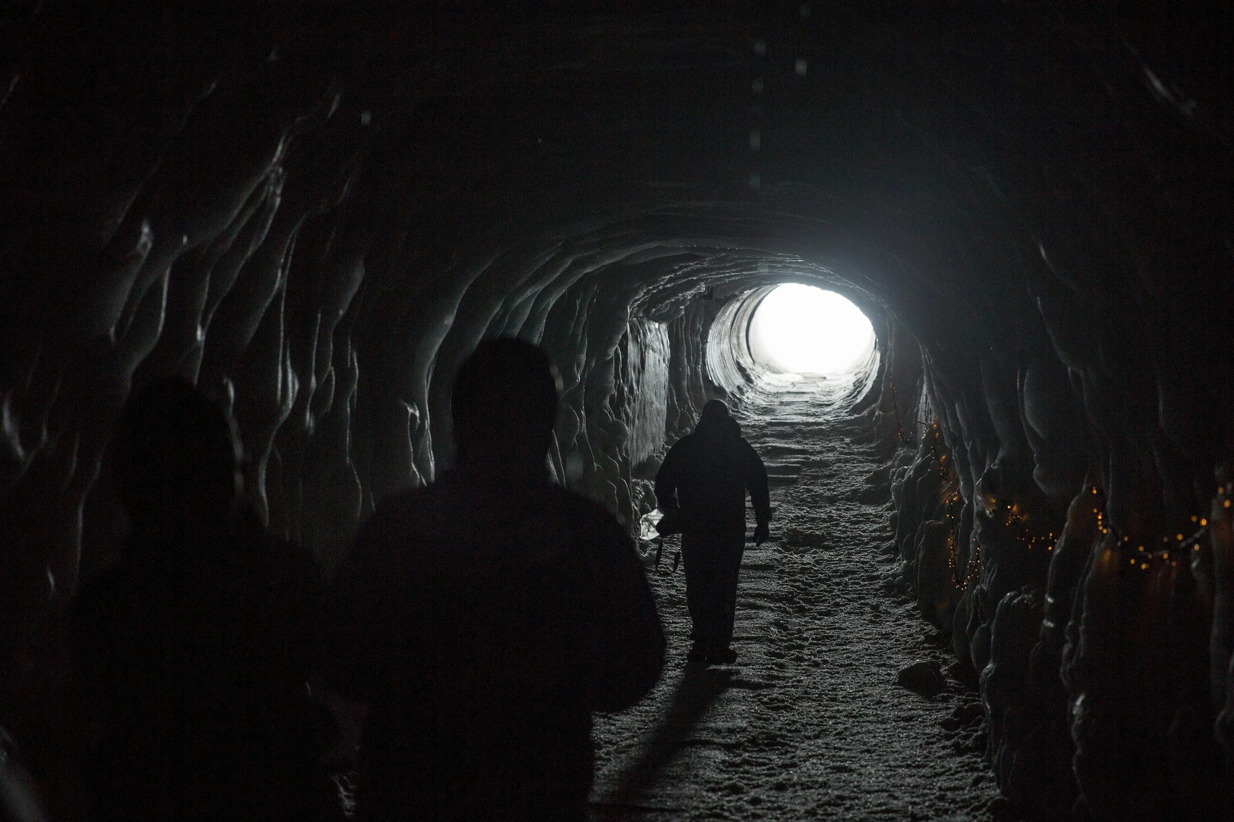 humans walking through tunnel