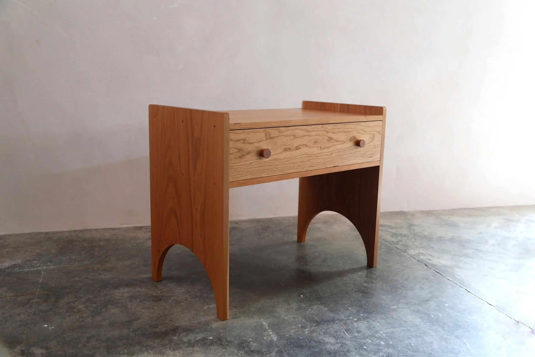   INQUIRE   Our Shaker Side Table is a robustly built heirloom piece of furniture with clean lines and solid wood joinery. The arched foot and slab leg recall Shaker meetinghouse benches, while the handmade wooden knobs add a bit of whimsy. The drawe