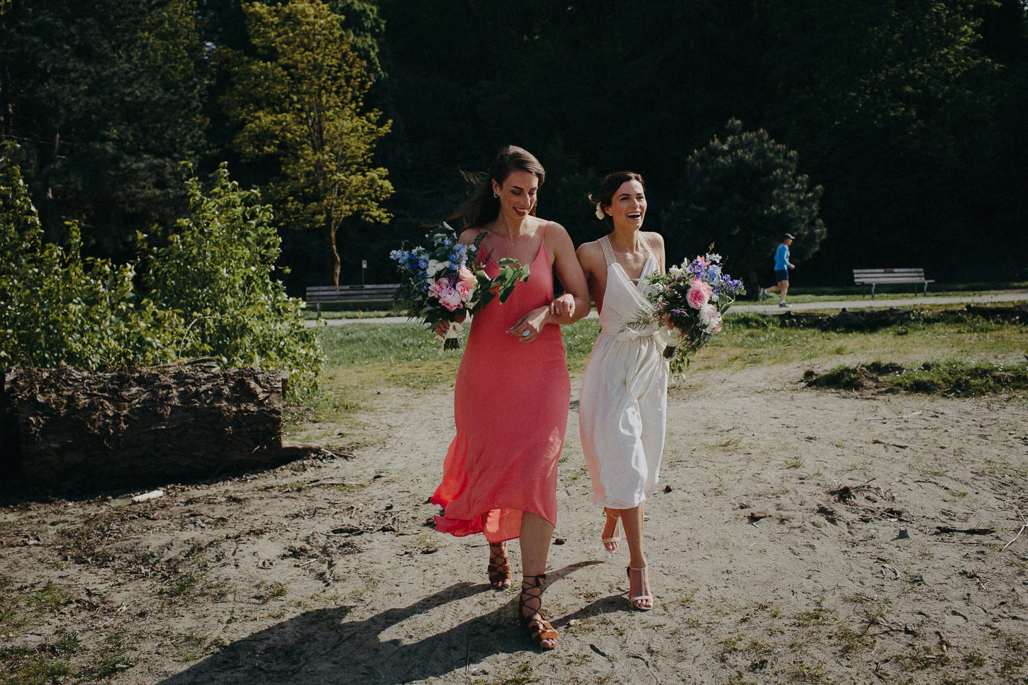 bride and maid of honor walking on beach
