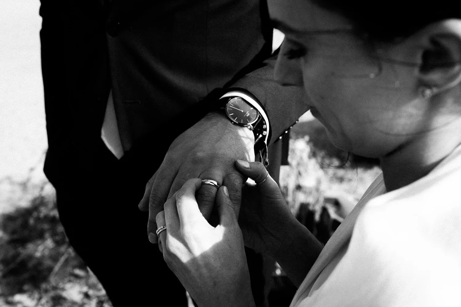 bride looking at the grooms ring