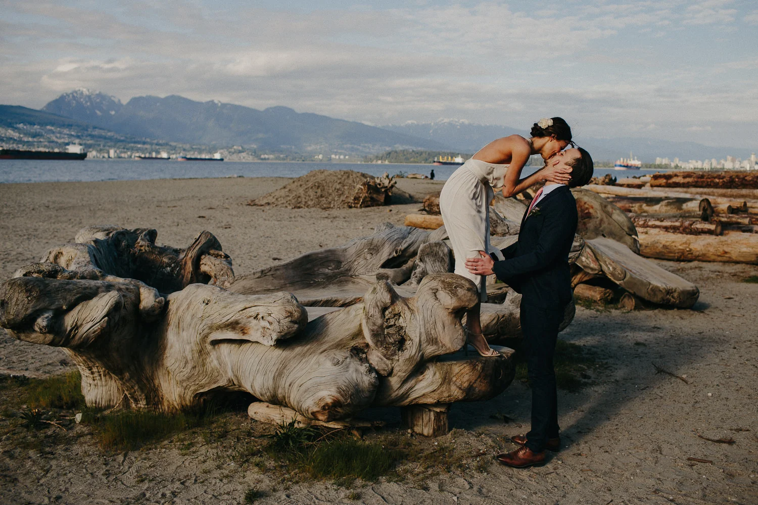 bride kissing groom while standing above him