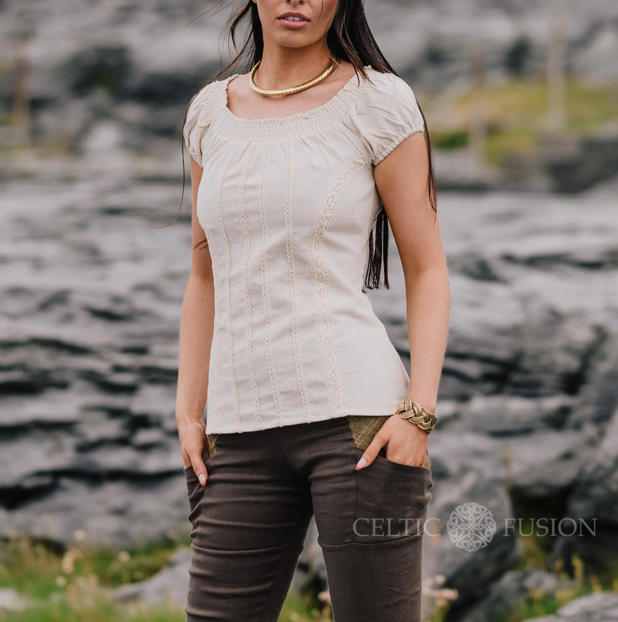 A romantic corset top inspired by folklore style, featuring puffed sleeves, cotton lace detailing, and a flattering corset tie back.