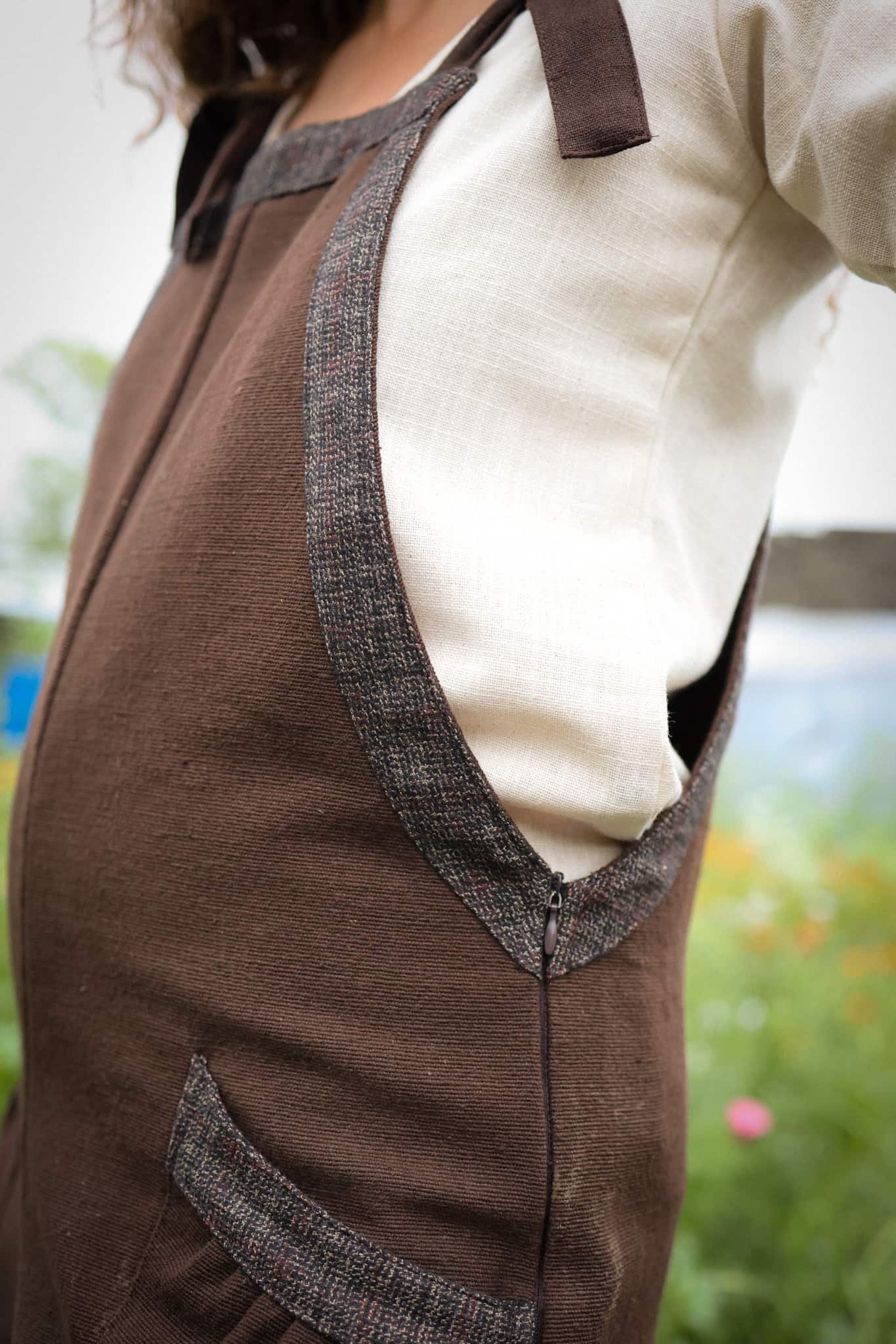 Discover our Meadow Brown Dungarees, an earthy brown jumpsuit trimmed with oak tweed, designed for folklore-inspired style, comfort, and everyday wear