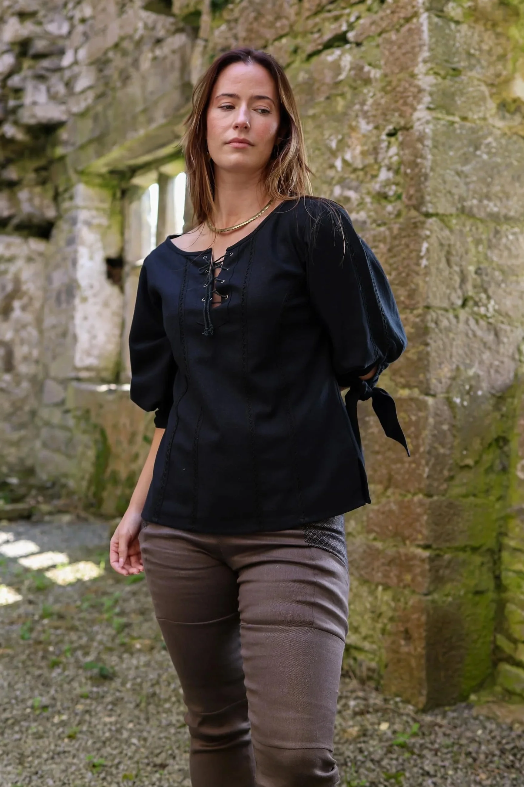 Black Grace O'Malley pirate queen shirt with lace-up tunic and knot-tie sleeves.