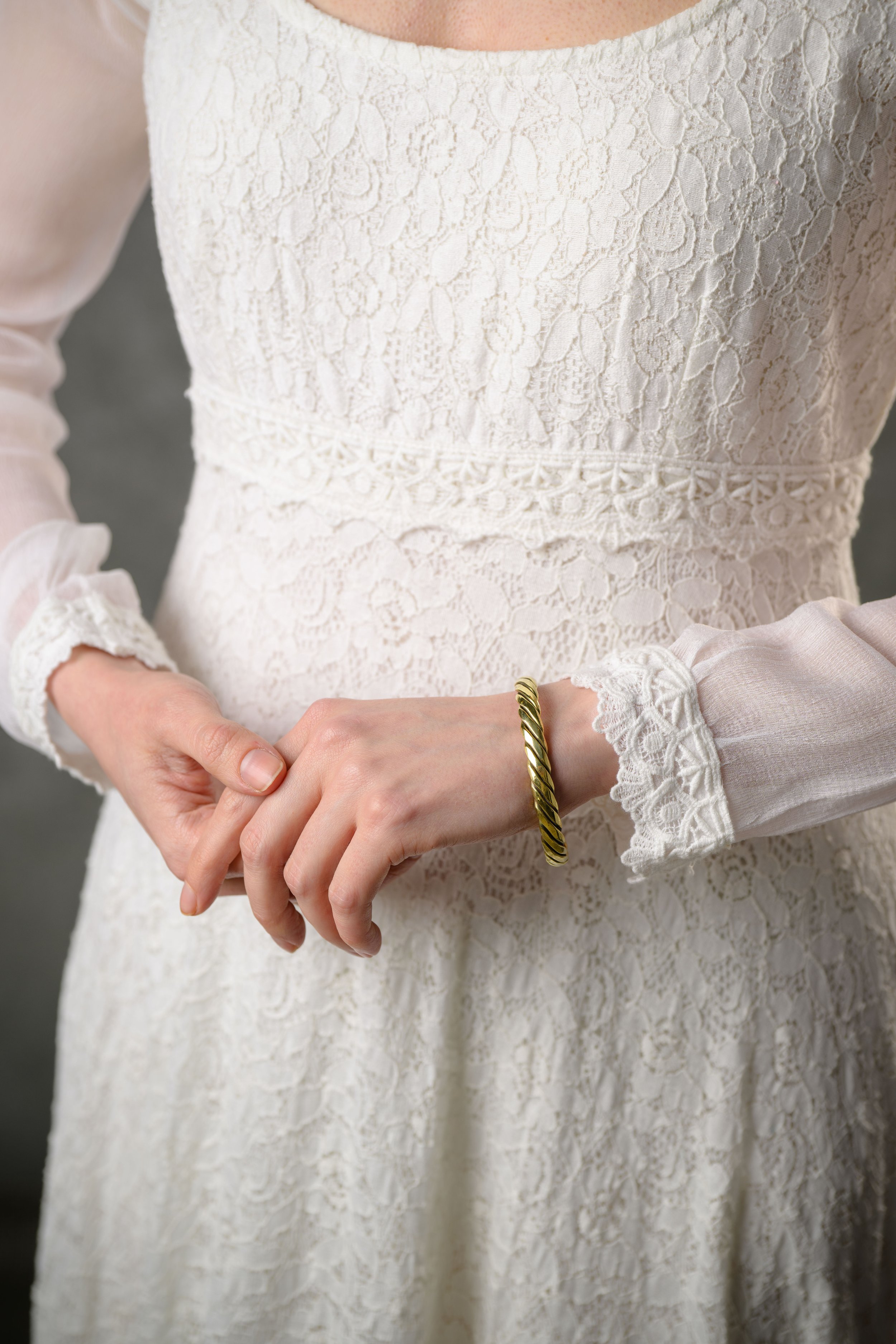 Lace sleeved wedding dress close up on model