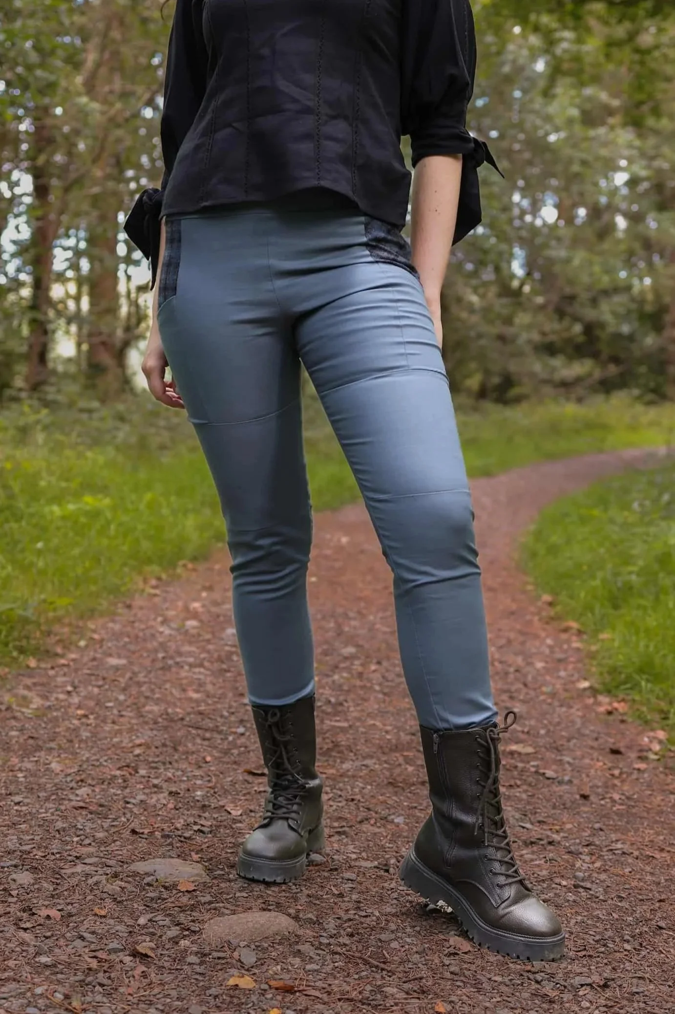 A model wears the Tara Linen Leggings, sustainable clothing linen blend trousers with tweed wool plaid pockets designed by Celtic Fusion.