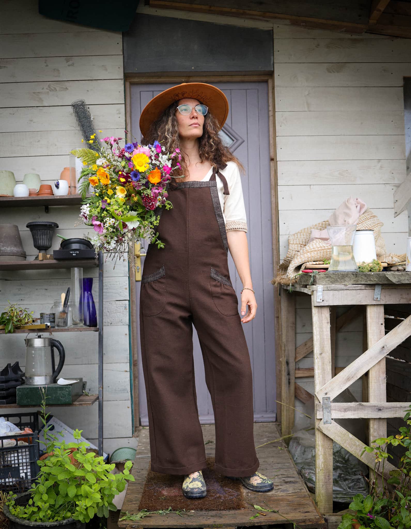 Discover our Meadow Brown Dungarees, an earthy brown jumpsuit trimmed with oak tweed, designed for folklore-inspired style, comfort, and everyday wear