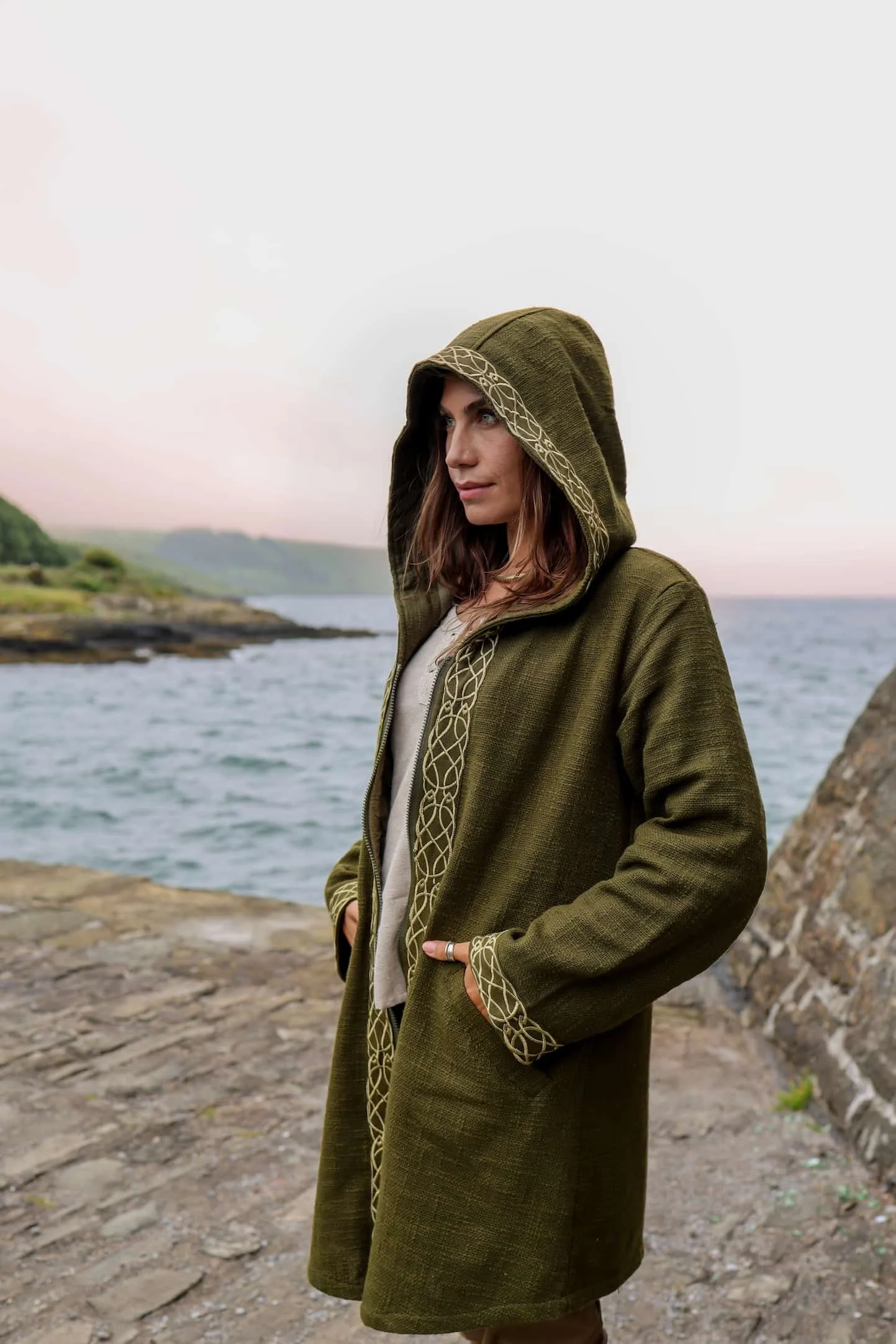 Discover a stylish Celtic jacket featuring Celtic knotwork embroidery, crafted from 100% heavy cotton slub with an Irish design, deep hood, pockets, and zipper closure.