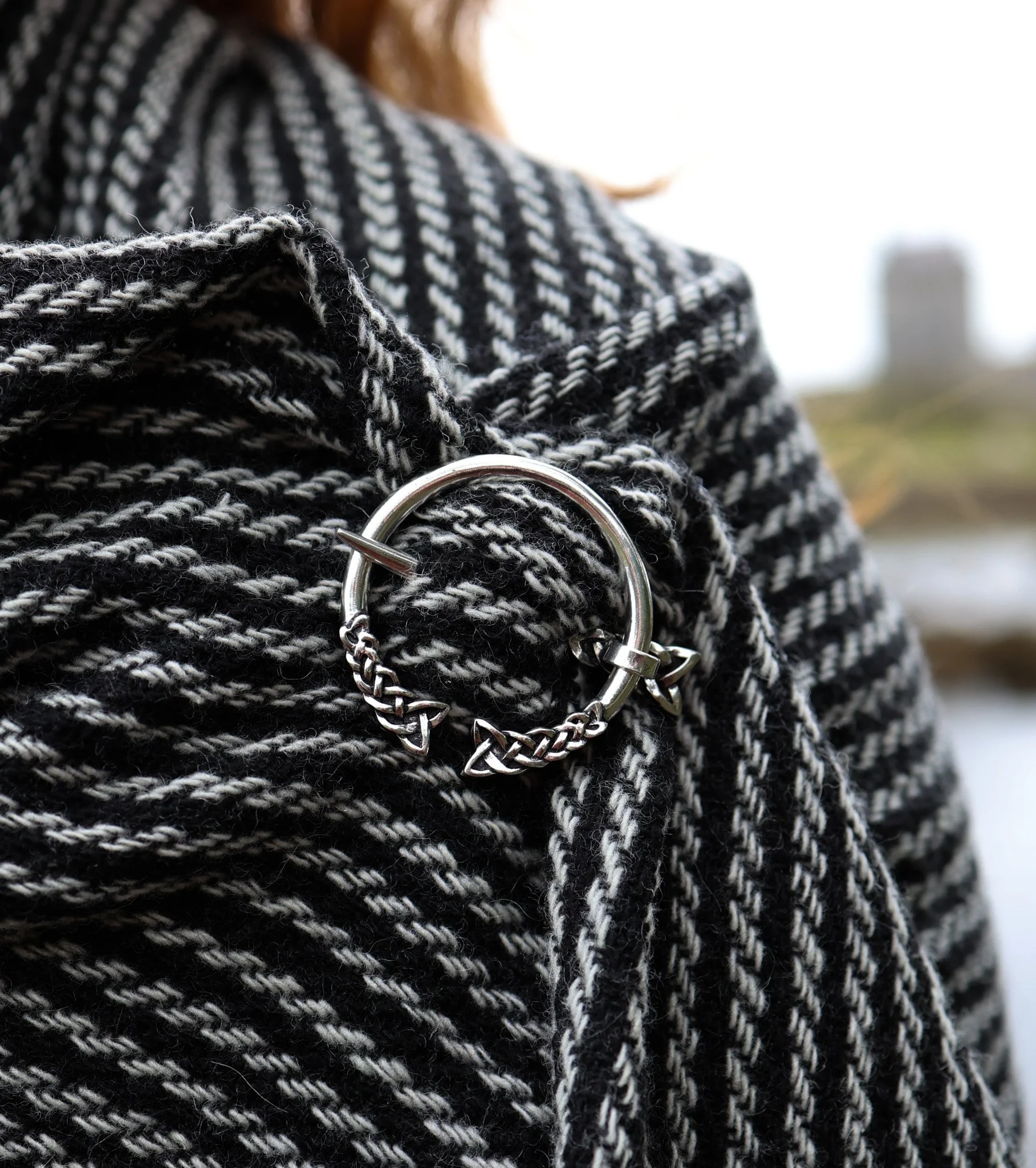 Celtic Trinity Knot Shawl Brooch, handcrafted from silver-plated brass with intricate triquetra knot detailing. A Celtic penannular brooch designed to secure handwoven shawls and cloaks