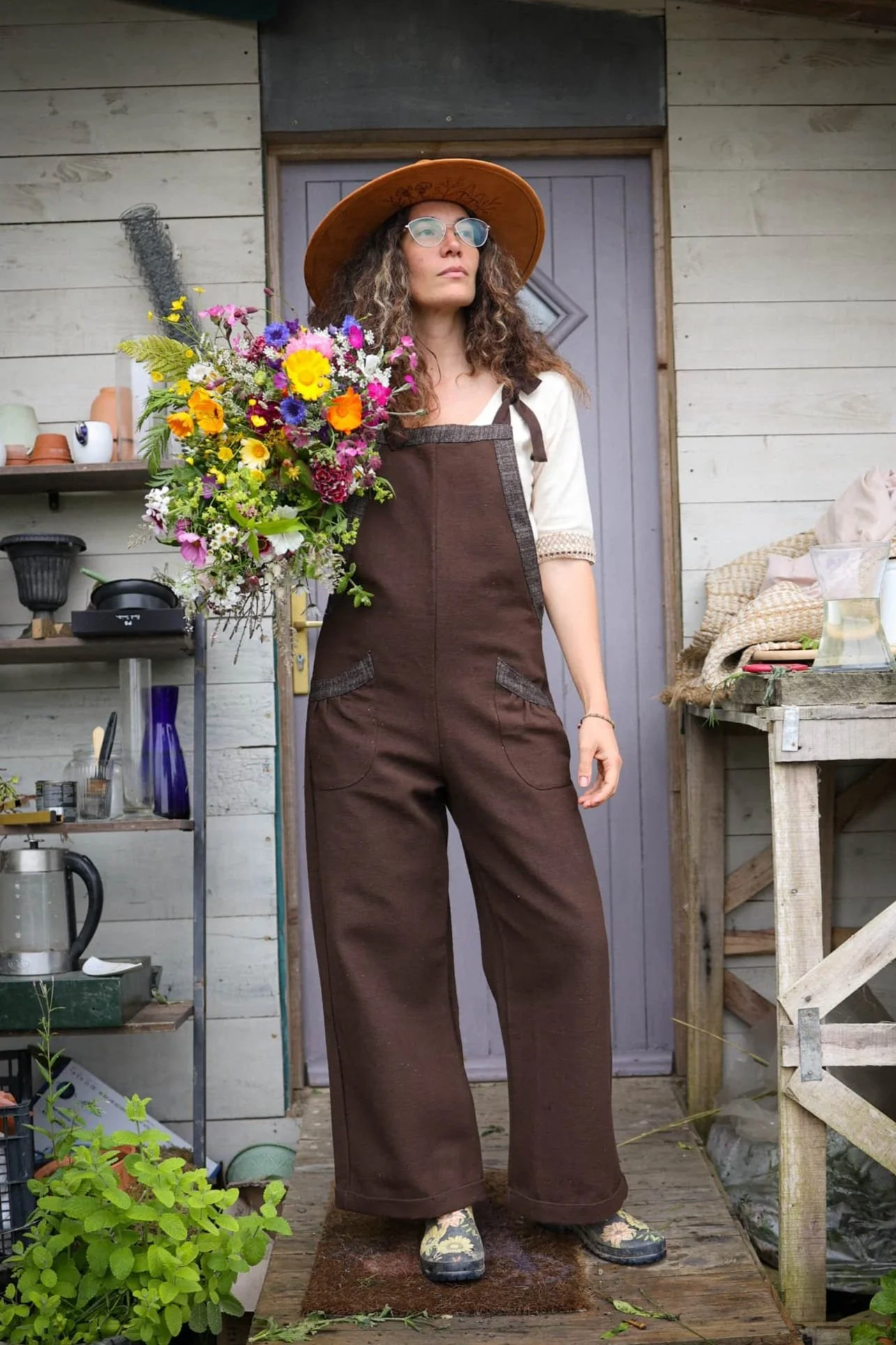 Discover our Meadow Brown Dungarees, an earthy brown jumpsuit trimmed with oak tweed, designed for folklore-inspired style, comfort, and everyday wear