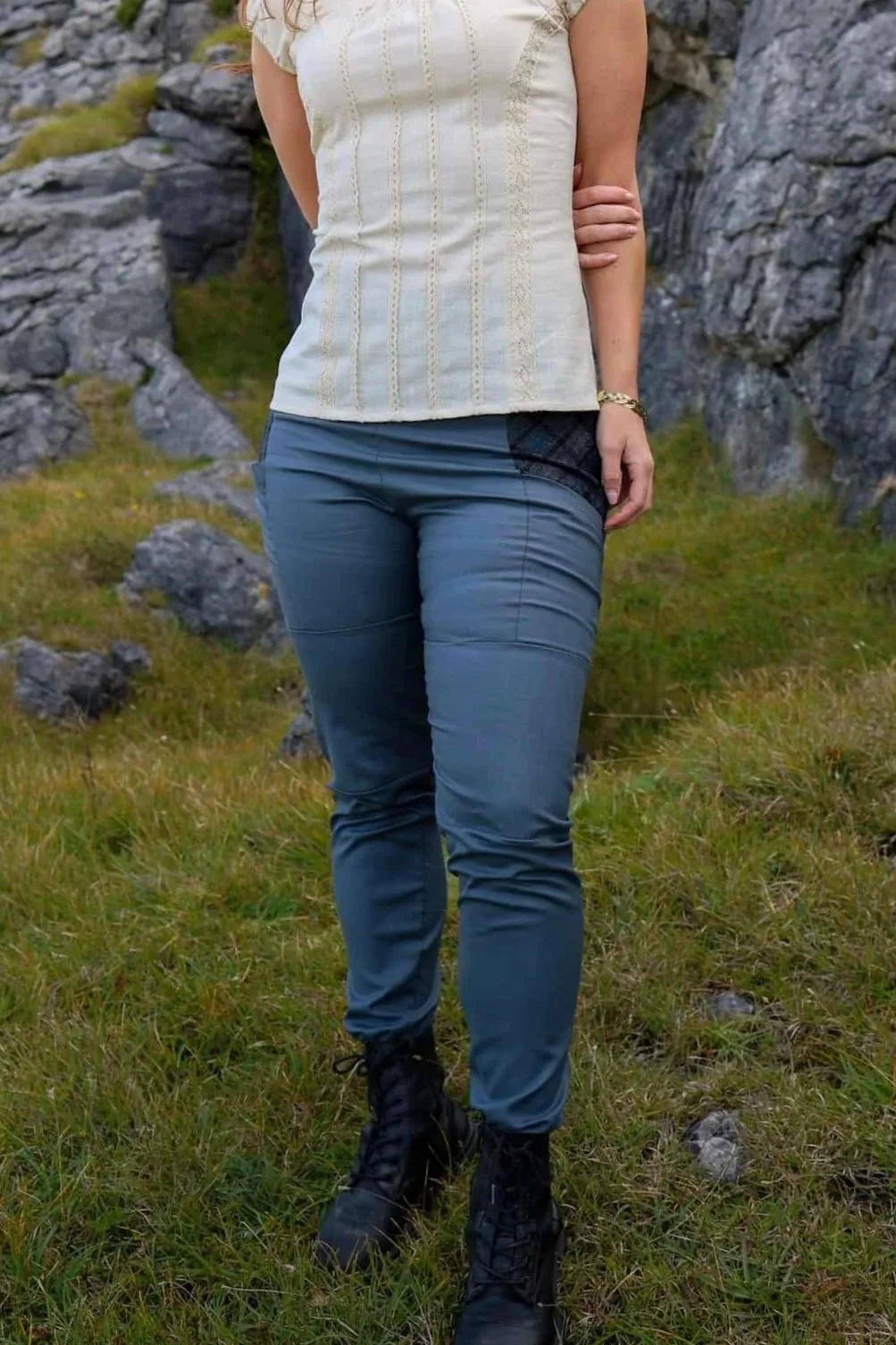 A model wears the Tara Linen Leggings, sustainable clothing linen blend trousers with tweed wool plaid pockets designed by Celtic Fusion.